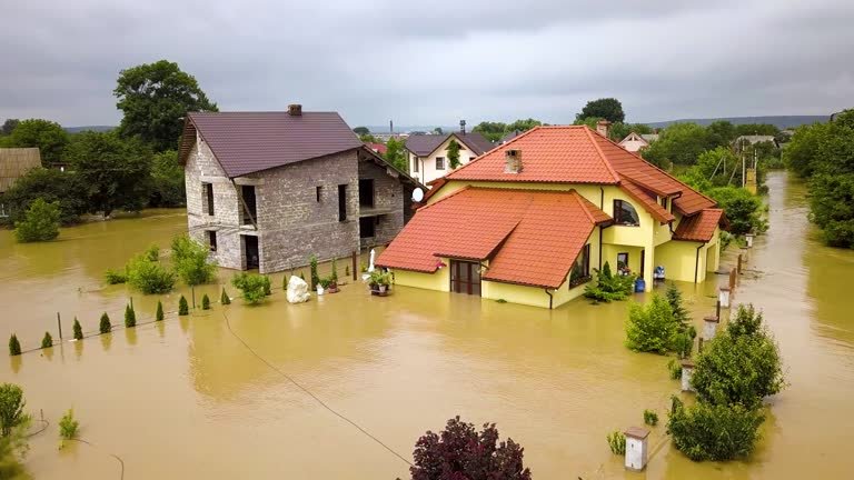 A house surrounded by flood water, highlighting the need forHouse Flooding Clean-Up Companies.