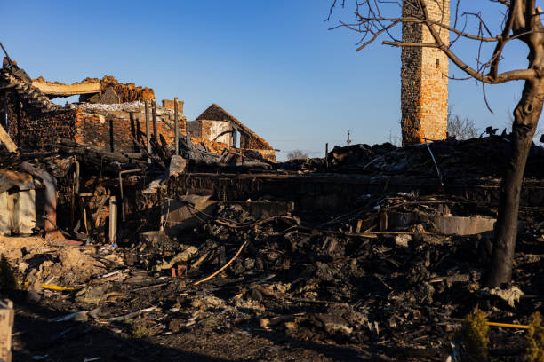 A charred room with a shattered window and door, representing the impact of fire damage and the restoration.