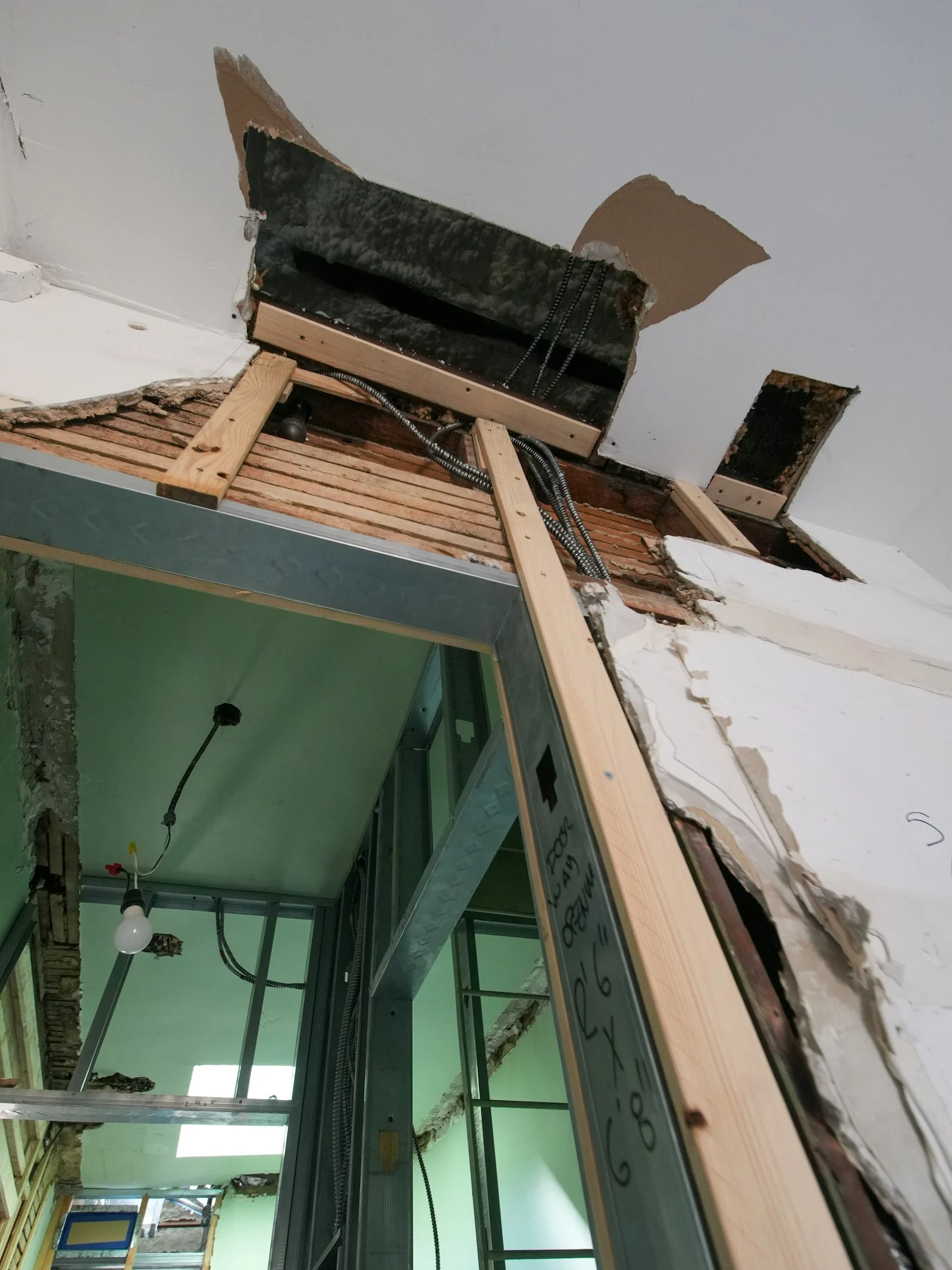 Water damaged ceiling opened up to dry the framing