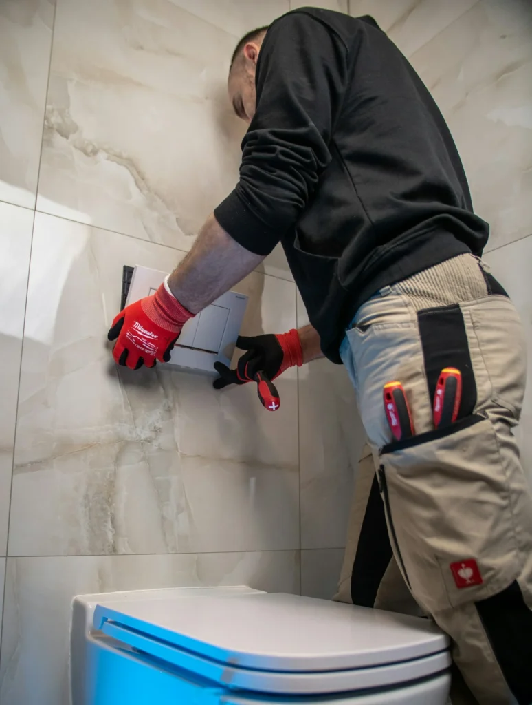 Technician with gloves working on a toilet sewage backup